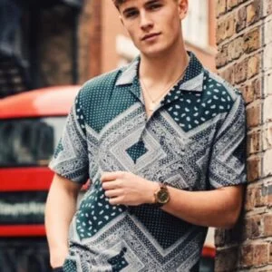 "Green and white geometric patterned short-sleeve shirt with collar, styled in urban streetwear."